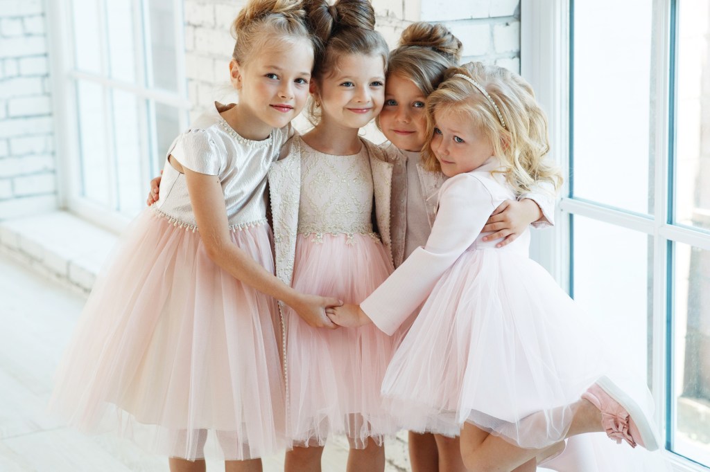 Claudia Schmidt putting with girls in beautiful dresses